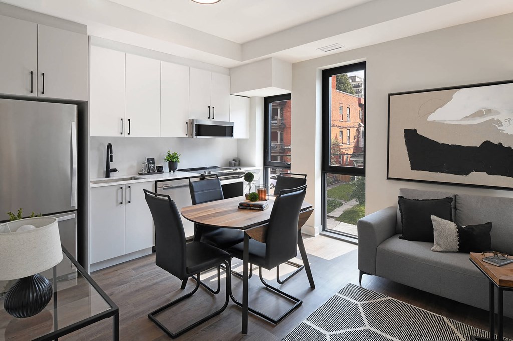 a kitchen and dining room with a table and chairs