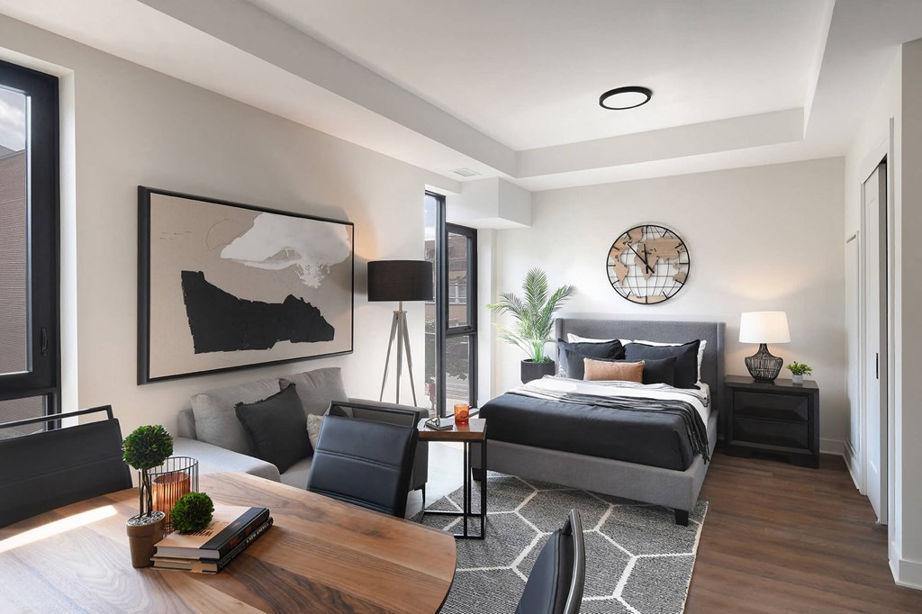 a bedroom with a bed and a couch and a table