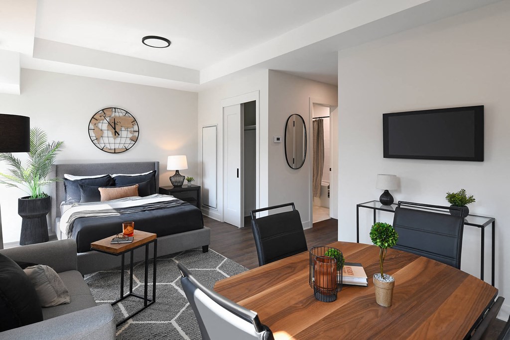 a living room with a couch and a table and a bed