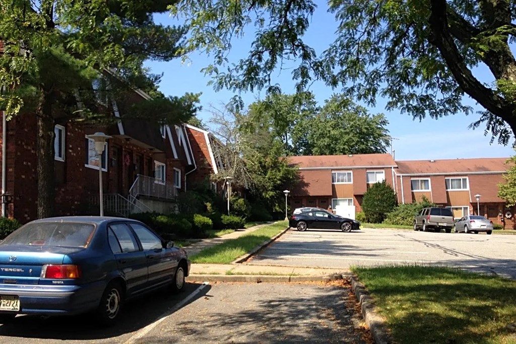 a street with cars parked in front of houses
