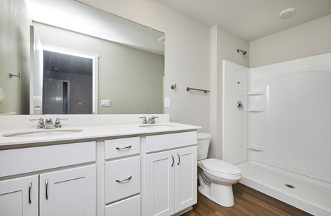 A white bathroom with a toilet, sink, and bathtub.