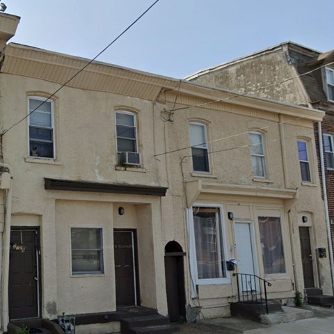 A row of houses with dark front doors.