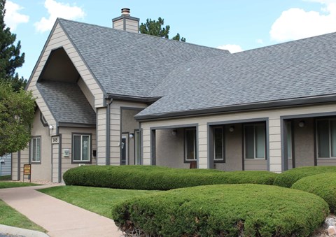 A house with a grey roof and a brown door.