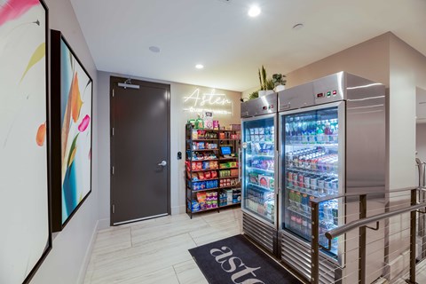 A modern kitchen with a refrigerator and a painting on the wall.
