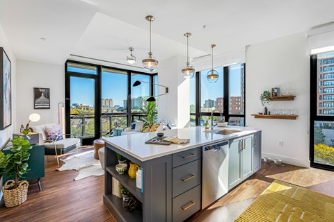 a kitchen with a large island and a view of a living room