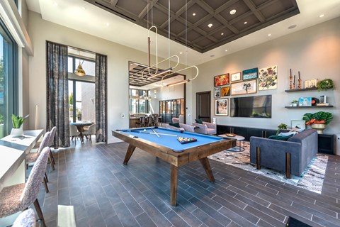 a clubhouse with a pool table and a tv