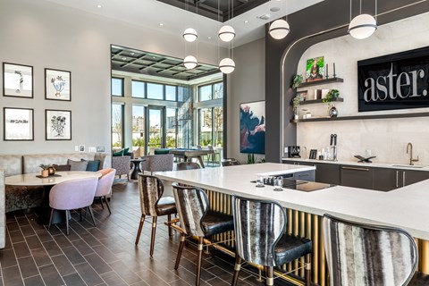 a communal table in a restaurant with chairs and a counter top