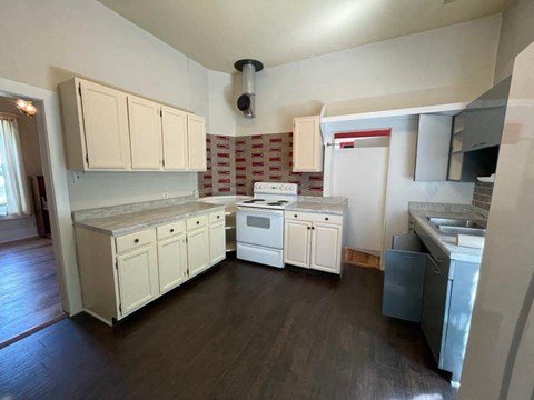 a kitchen with a stove and a sink