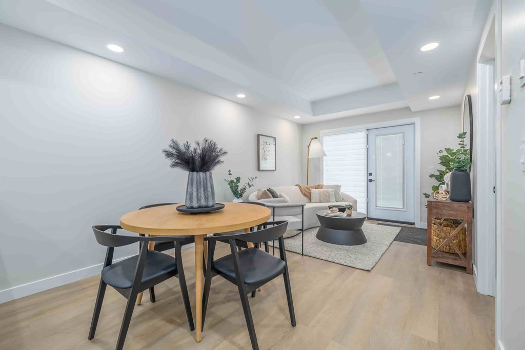 A modern dining room with a round table and chairs.