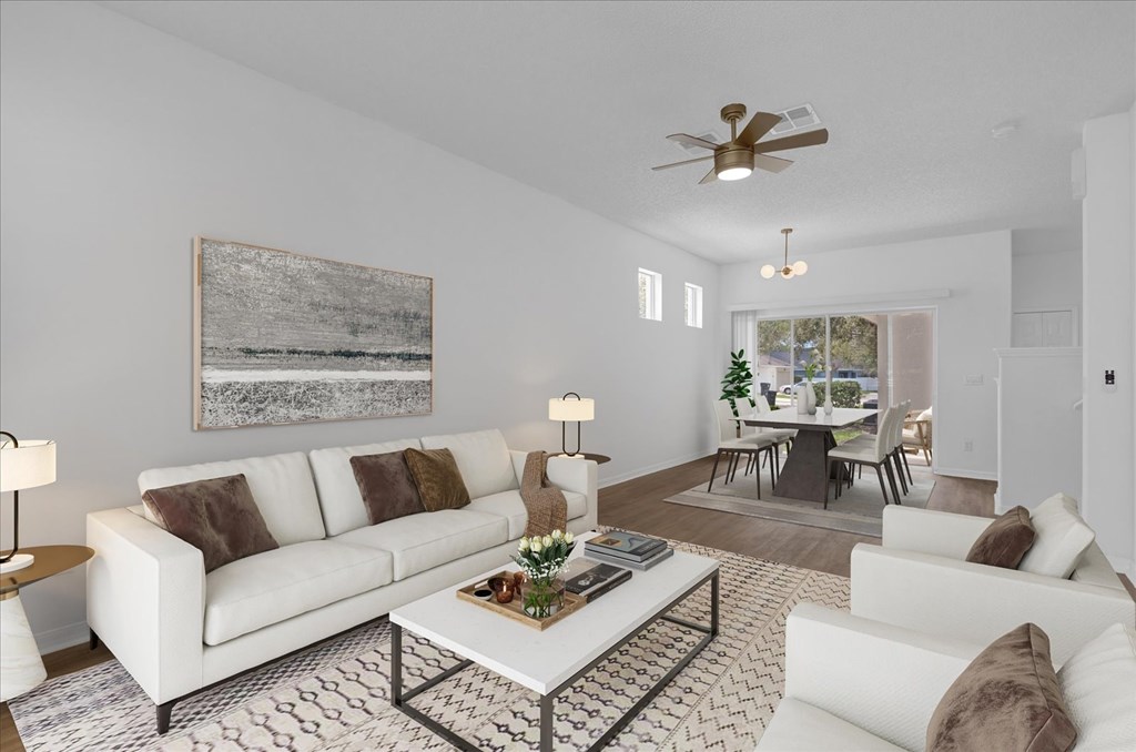 a living room with white couches and a coffee table