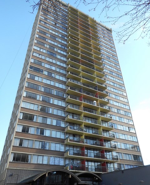 A tall building with many windows and balconies.