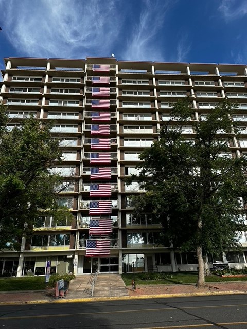 an apartment building with the flag displayed in front of it