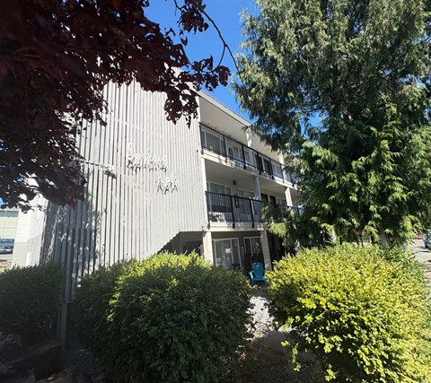 A building with the word "Parker" on it is surrounded by greenery.