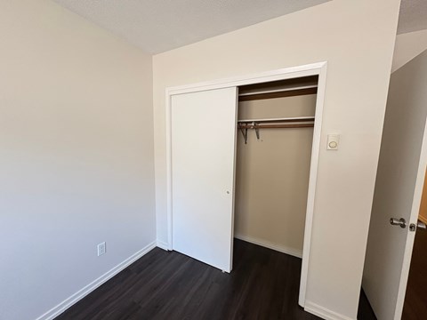 A white door is open to a room with a brown shelf.