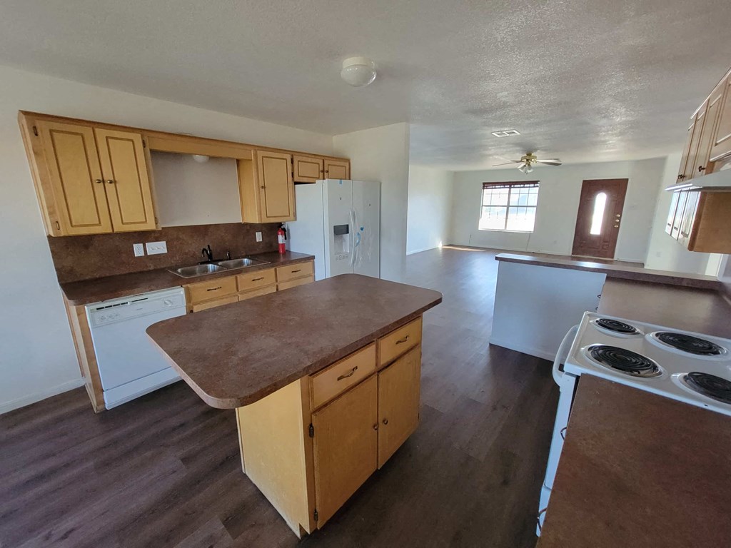 a kitchen with wooden cabinets and a stove and a sink