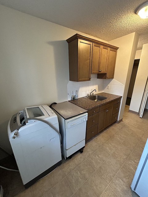 a kitchen with a washer and dryer in it