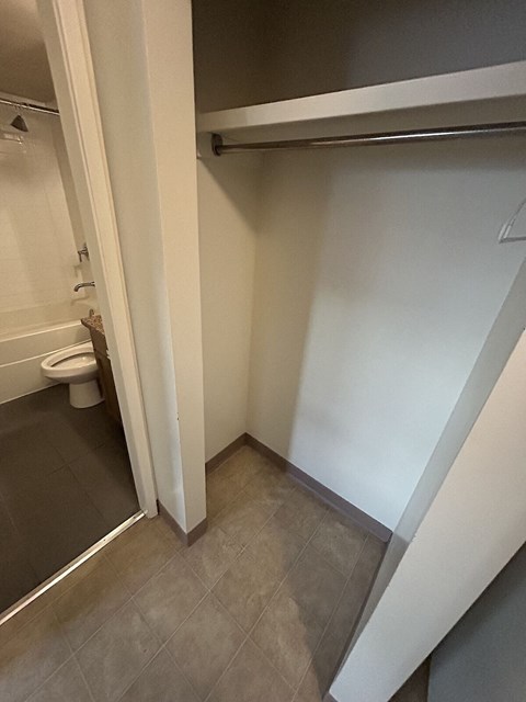 a small bathroom with a toilet and a sliding door