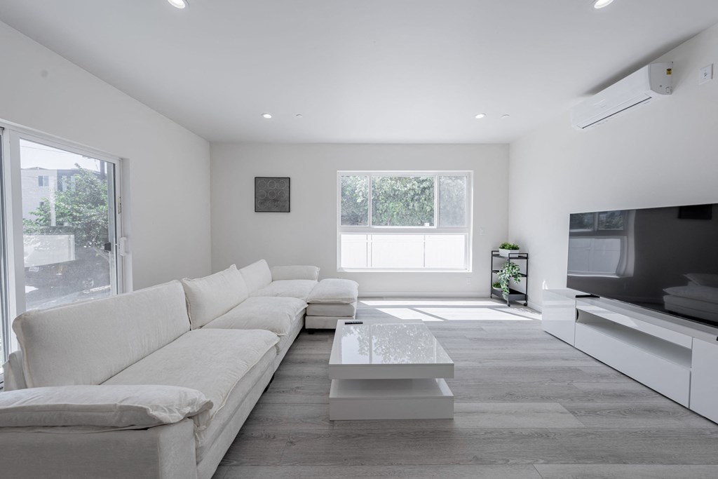a white living room with a white couch and a coffee table