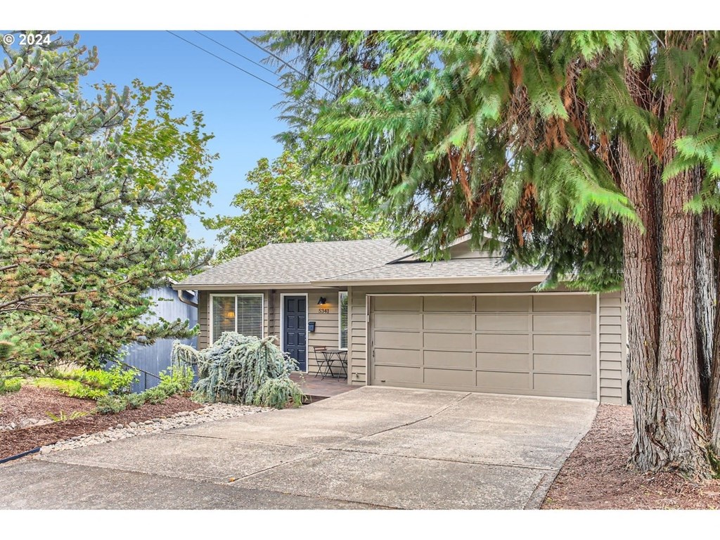 a home with a driveway and a garage door