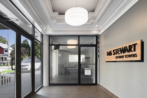 The lobby of a building with a sign that reads "146 STEWART STEWART TOWERS".