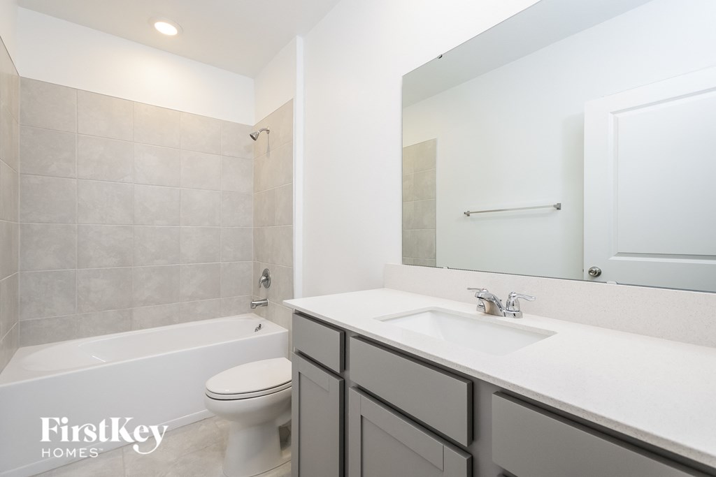 a bathroom with a sink and a toilet and a bath tub