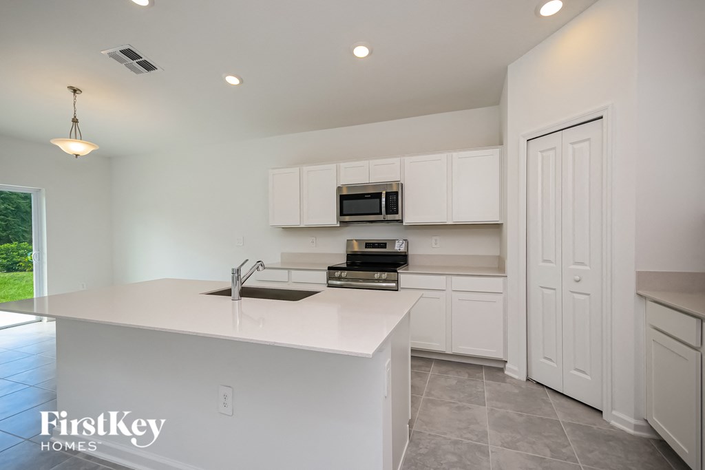 a kitchen with white cabinets and a white counter top