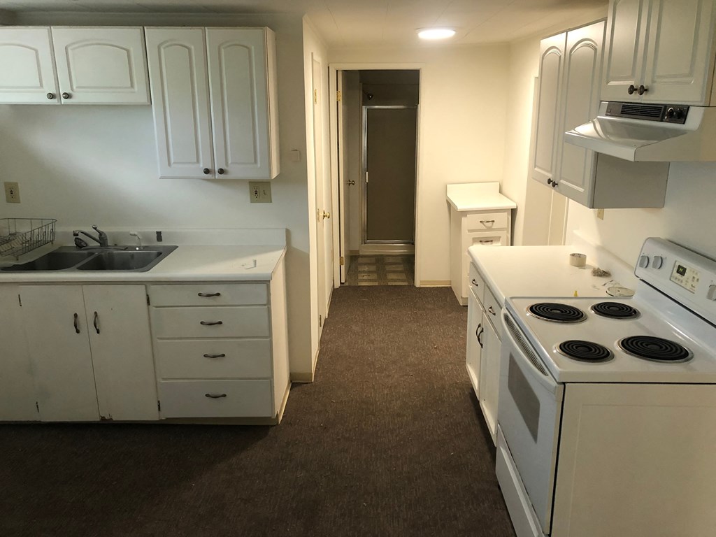 a kitchen with white appliances and white cabinets