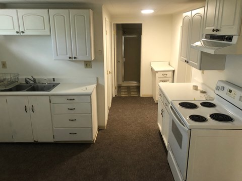 a kitchen with white appliances and white cabinets