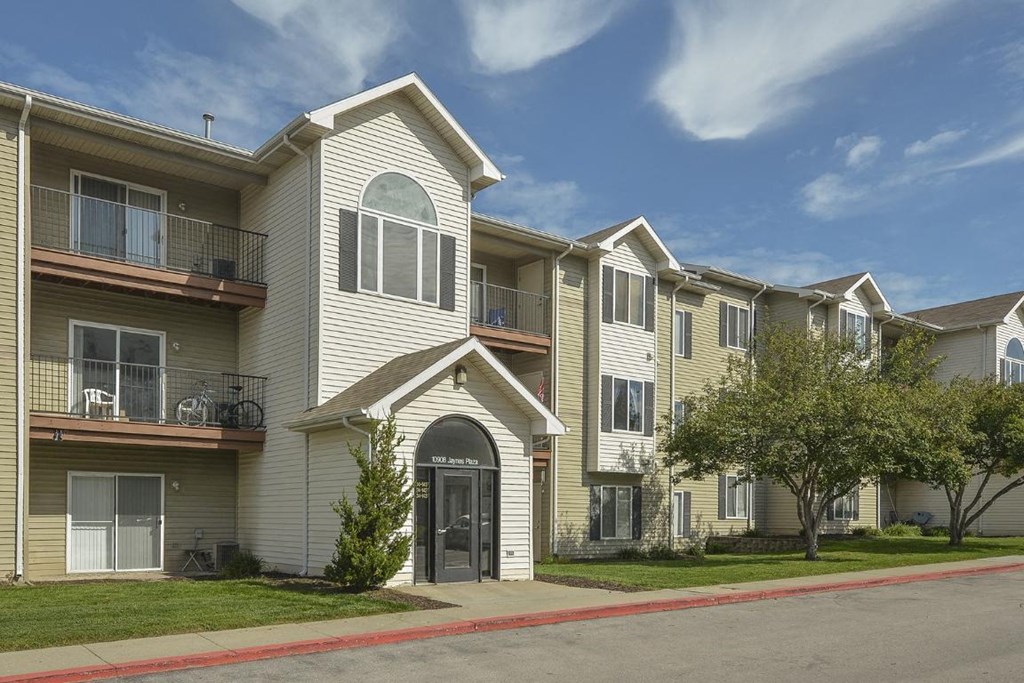 an apartment building with a street in front of it