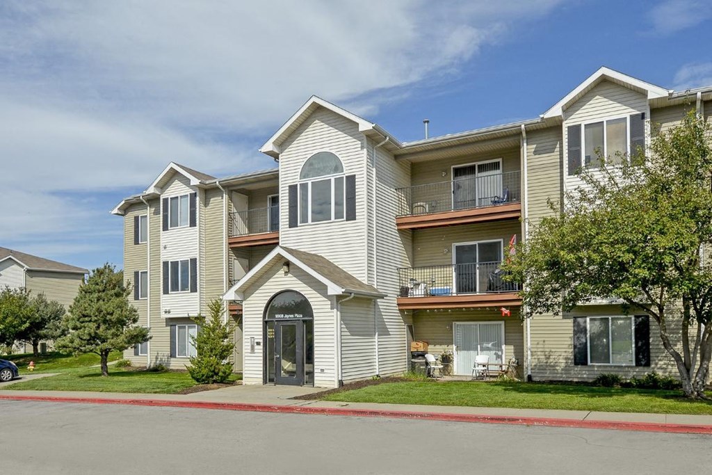 an apartment building with a street in front of it