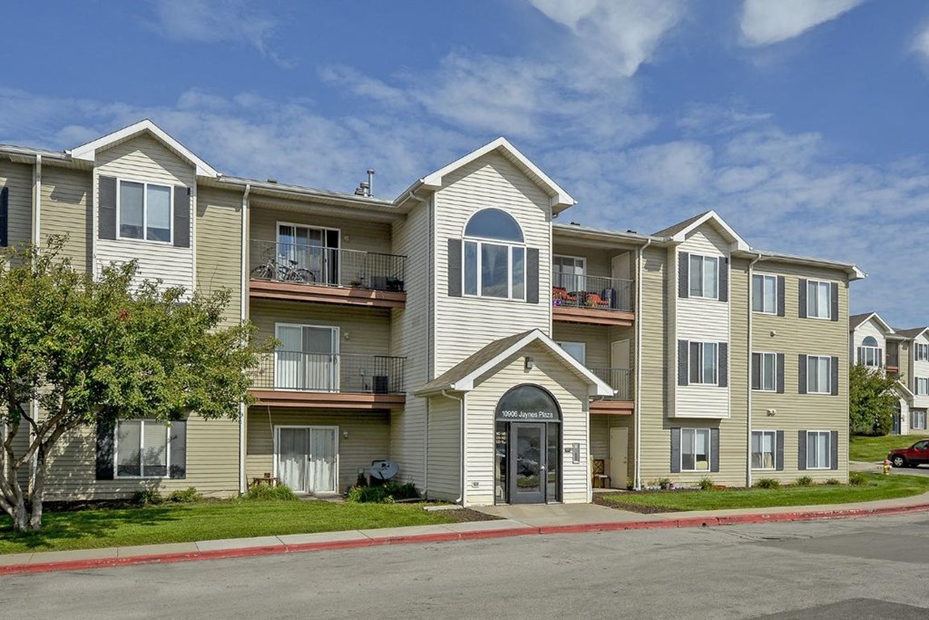 an apartment building with a street in front of it