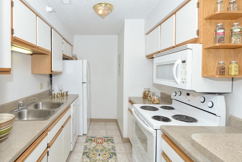 a kitchen with a stove microwave and a sink