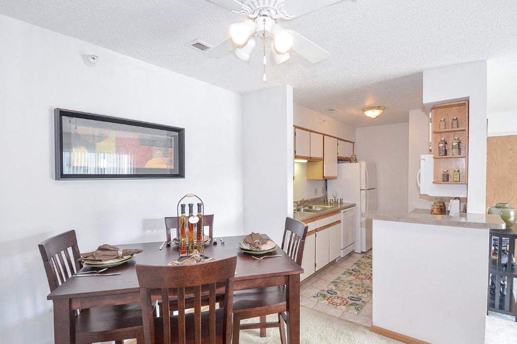 a dining room with a table and chairs and a kitchen