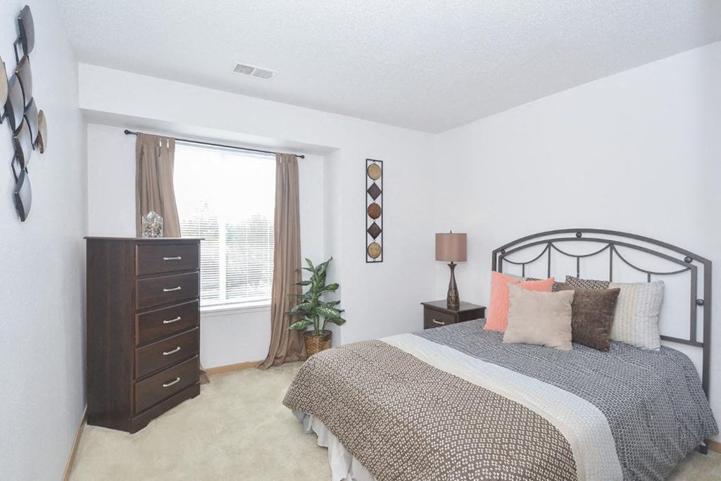 a bedroom with a bed and a dresser