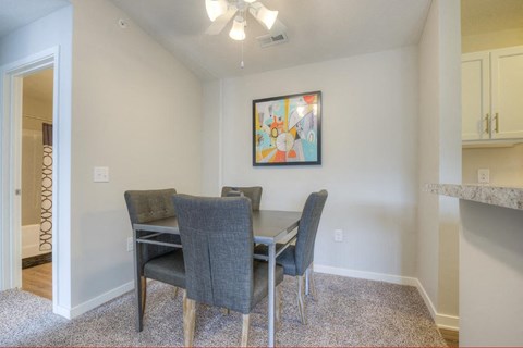 a dining room with a table and chairs