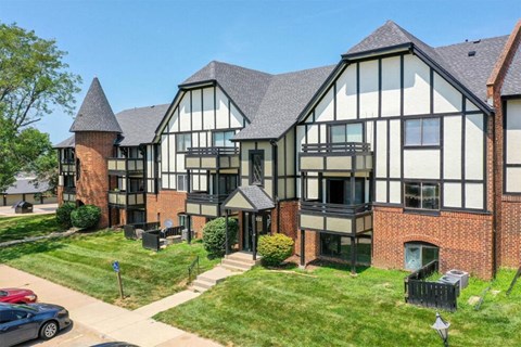 the view of an apartment building from the street