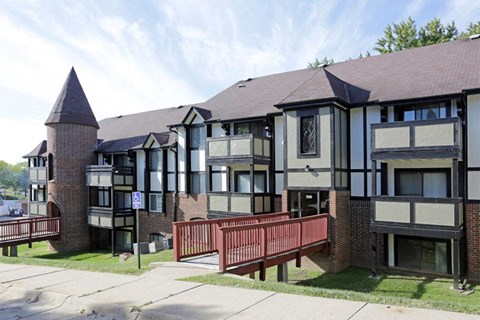 an apartment building with a red bench in front of it