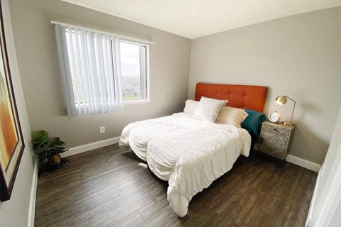 a bedroom with a bed and a window