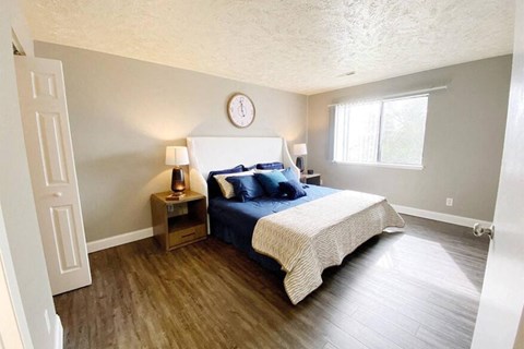 a bedroom with a bed and a clock on the wall