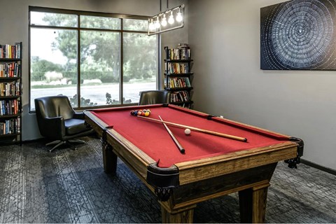 a games room with a red pool table