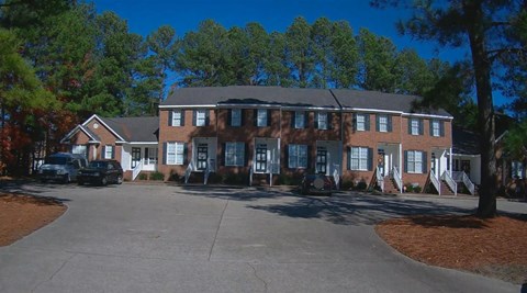 A large building with a parking lot in front of it.
