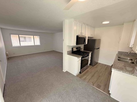 A kitchen area with a stove, microwave, and oven.