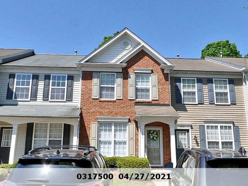 A house with a black car in front of it.