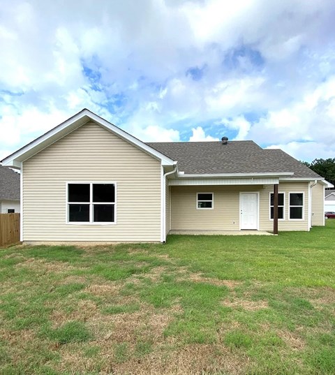 the front of a house with a yard in front of it