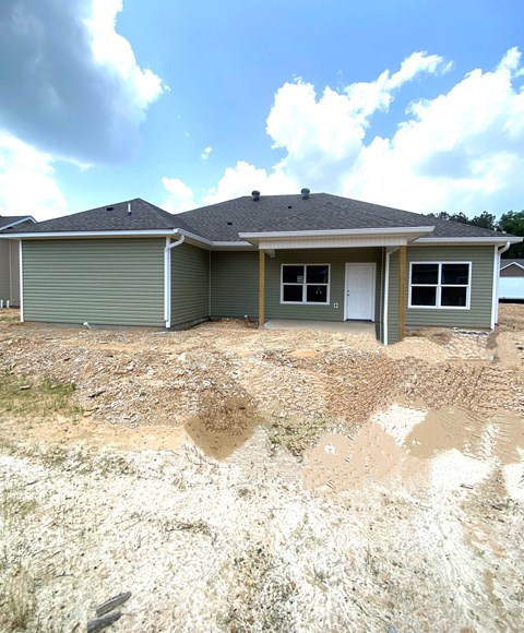 a house with a dirt lot in front of it