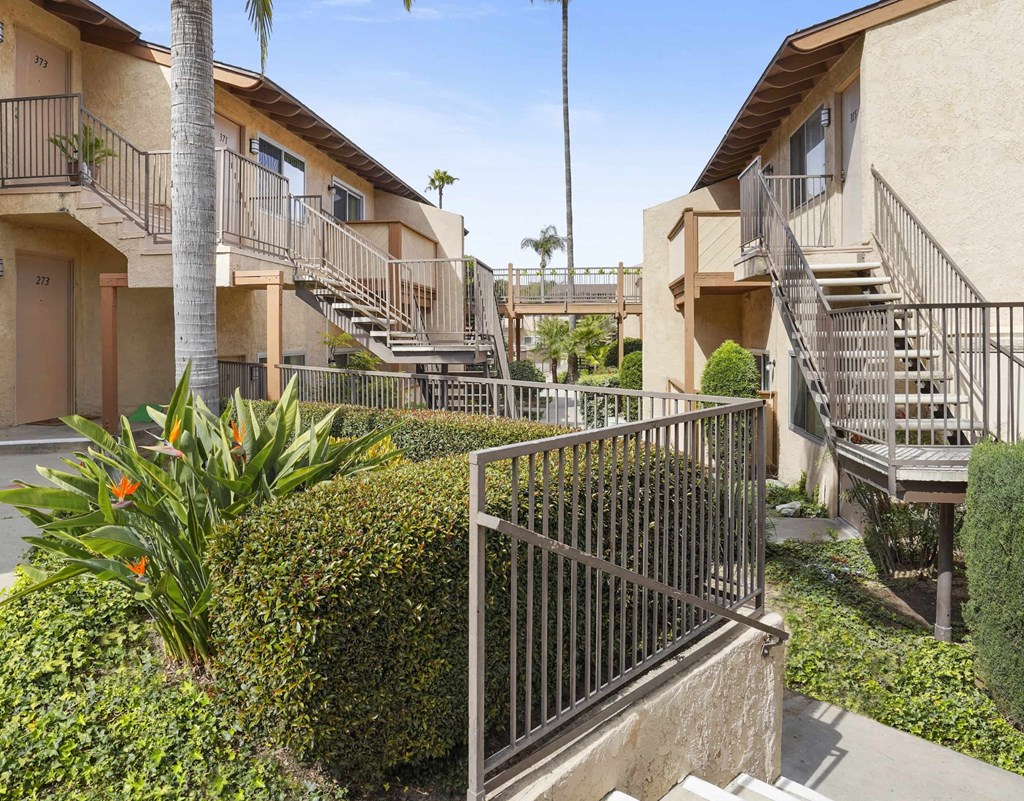 A sunny day at a residential complex with a clear blue sky.
