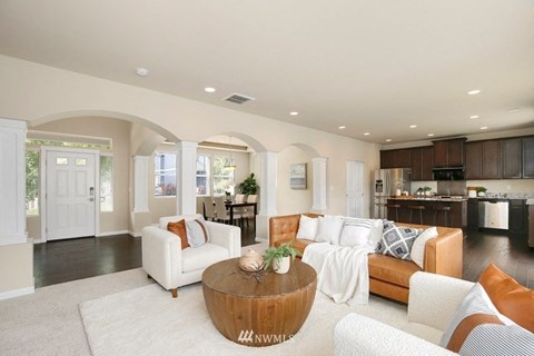 A living room with a white couch and a coffee table.
