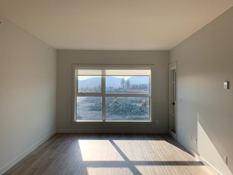 A room with a large window overlooking a snowy landscape.