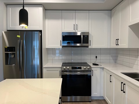 A modern kitchen with a black stove top oven.