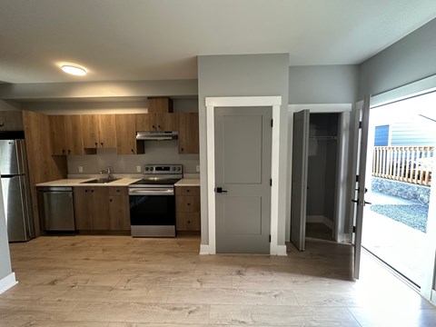 A kitchen with wooden cabinets and a refrigerator.